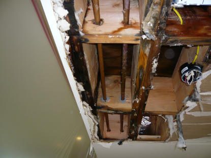 Ceiling Leak: Water damage ceiling caused by toilet flange leak